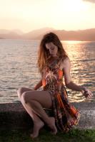 girl play with her dress at sun set