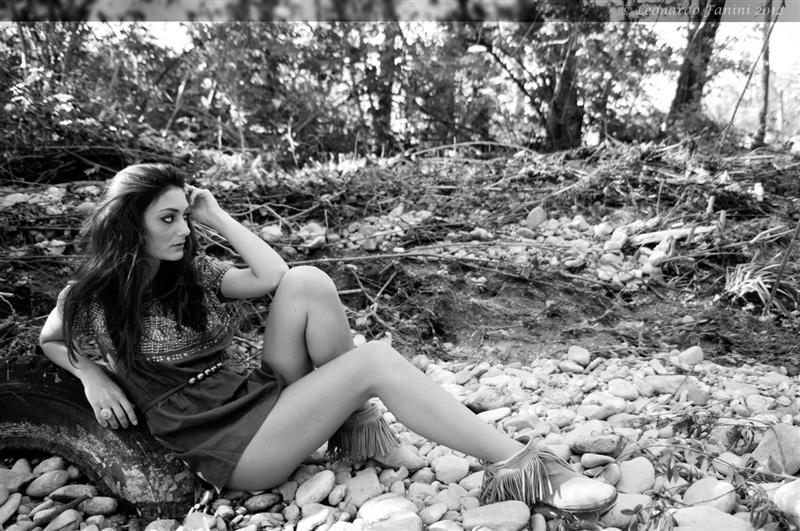 girl sitting on a old wheel